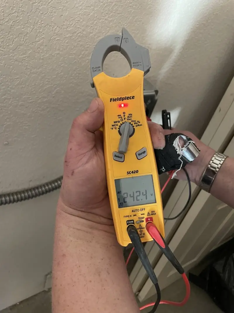 Voltage testing with clamp meter during Electrical Installation Services in Westmoreland